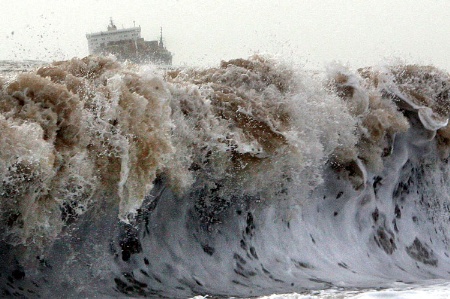 Ship riding huge waves