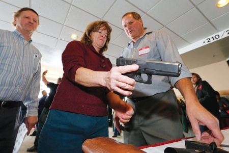 Female teacher holding a handgun