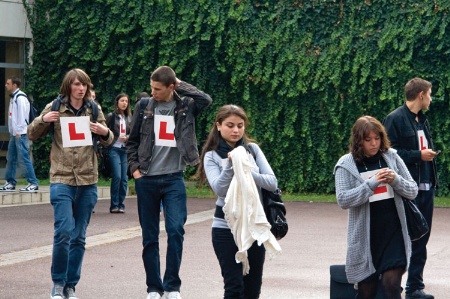 Group of young students wearing learner plates on chest
