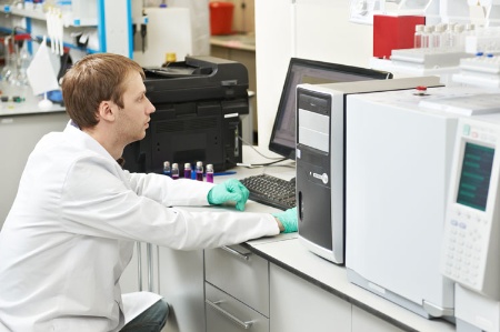 Male scientist working at PC workstation