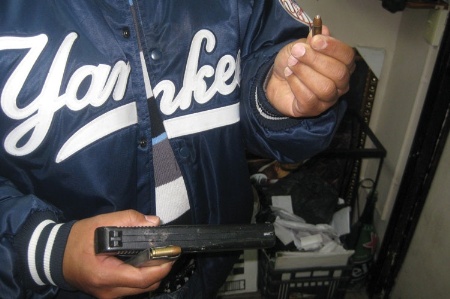 Man holding pistol and bullet