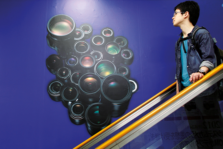 A man on an escalator in Japan A man on an escalator in Japan