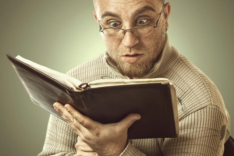 Confused man reading book Confused man reading book