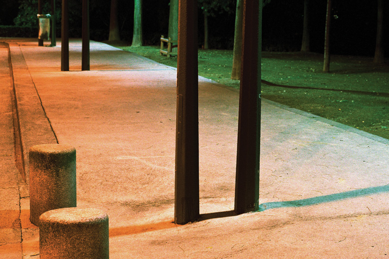 Empty pavement lit by street lights Empty pavement lit by street lights