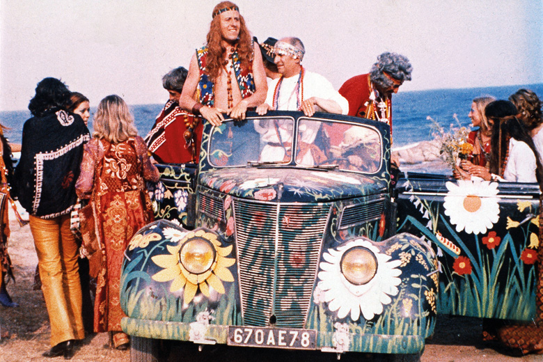 Group of hippies gathered around car Group of hippies gathered around car