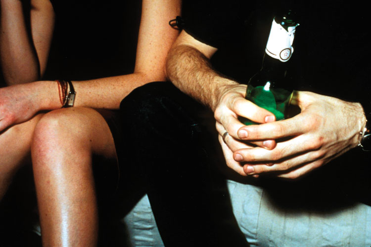 Man and woman seated, drinking alcohol Man and woman seated, drinking alcohol