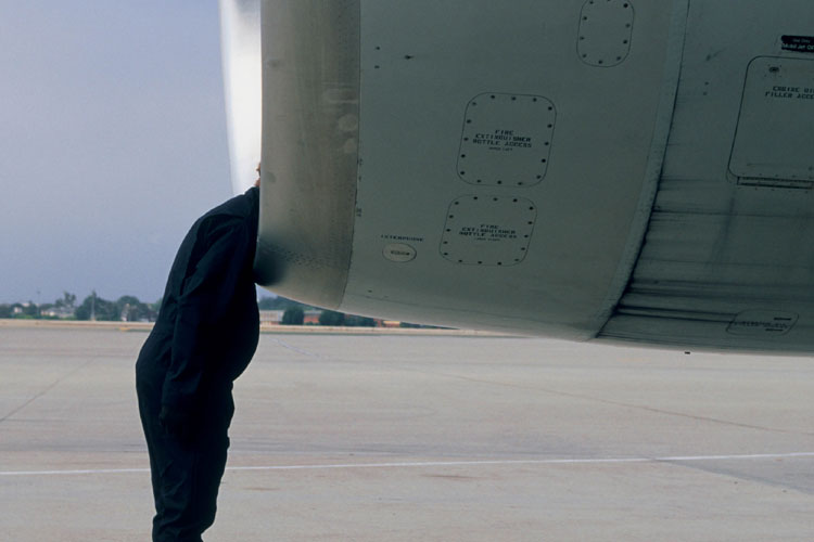 Man leaning head into jet engine Man leaning head into jet engine