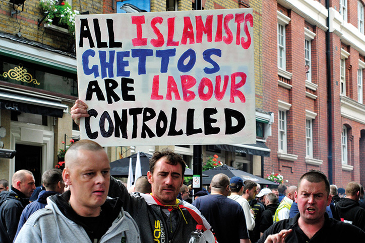 Protesters holding 'All Islamists ghettos are Labour controlled' placard Protesters holding 'All Islamists ghettos are Labour controlled' placard