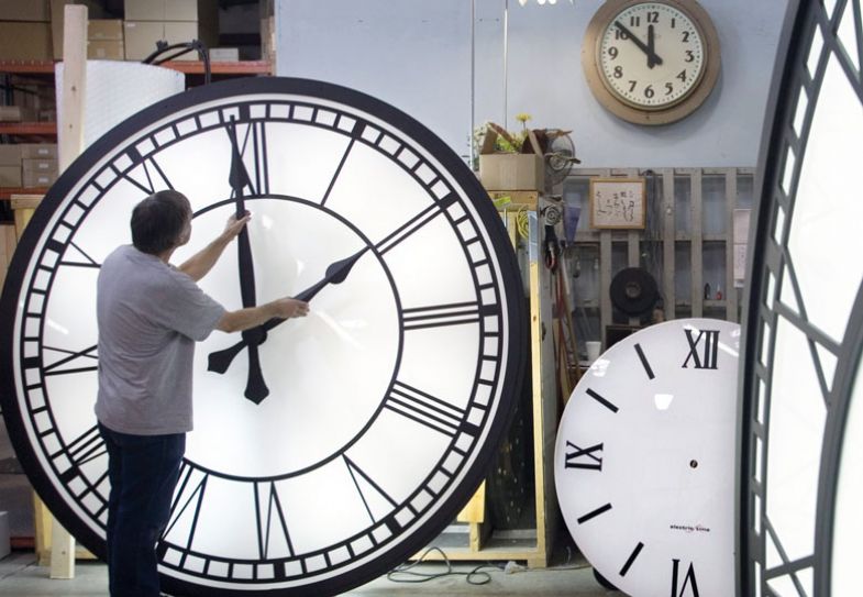 A worker at Electric Time adjusts the hands on a clock A worker at Electric Time adjusts the hands on a clock to illustrate Timetabling my life