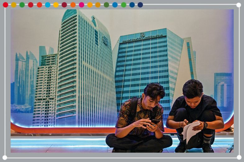 People fill out applications during a job fair organised by Airlangga University in Surabaya on 29 April 2025