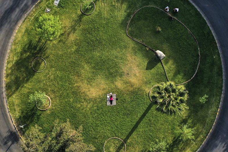 Aerial view of a woman at an empty park in Santiago on April 20, 2020 Aerial view of a woman at an empty park in Santiago on April 20, 2020