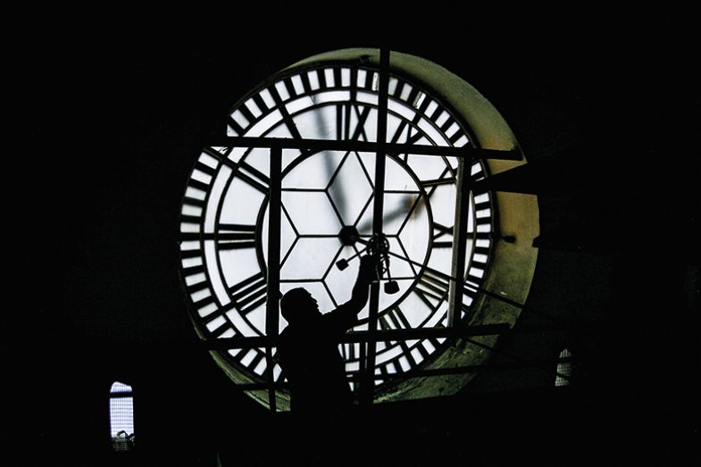 person fixing giant clock person fixing giant clock