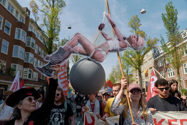 Dutch minister of education, culture, and science Eppo Bruins is featured in a comparison to Miley Cyrus sitting on a wrecking ball during a protest march marking International Workers’ Day on 1 May 2025 in Amsterdam, Netherlands. Dutch minister of education, culture, and science Eppo Bruins is featured in a comparison to Miley Cyrus sitting on a wrecking ball during a protest march marking International Workers’ Day on 1 May 2025 in Amsterdam, Netherlands.
