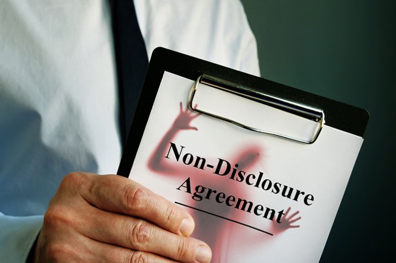 A figure trapped in a non-disclosure agreement.