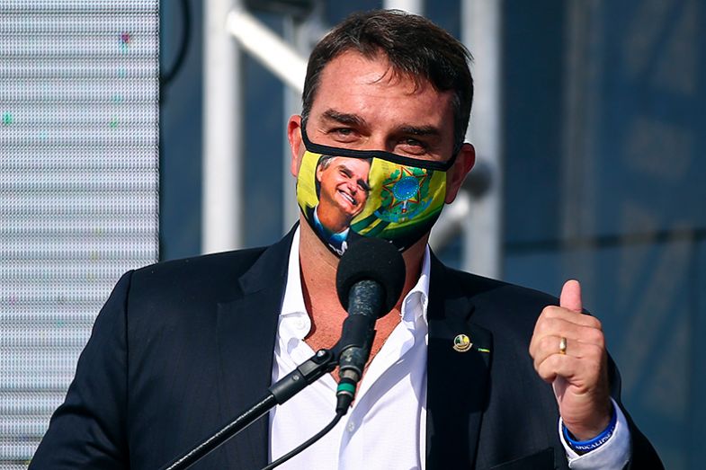 Flávio Bolsonaro speaks during the opening ceremony of the festivities for the 90th anniversary of the statue of Christ the Redeemer on 1 March 2021 in Rio de Janeiro, Brazil. He is wearing a facemask depicting his father Jair Bolsonaro. Flávio Bolsonaro speaks during the opening ceremony of the festivities for the 90th anniversary of the statue of Christ the Redeemer on 1 March 2021 in Rio de Janeiro, Brazil. He is wearing a facemask depicting his father Jair Bolsonaro.