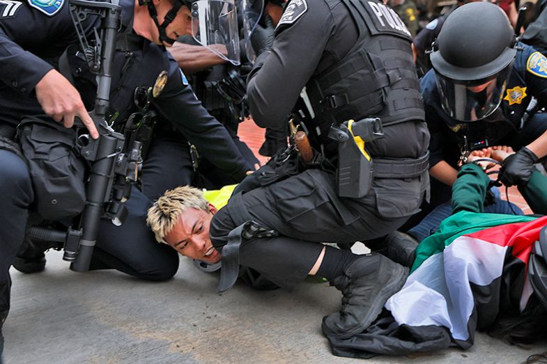 Pro-Palestine demonstrators are taken into custody by police as they break up the pro-Palestine encampment at UCI in Irvine, US, 15 May 2024.