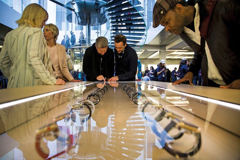 People browse wearable tech in a store People browse wearable tech in a store