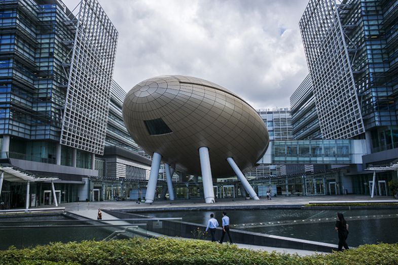 People walk along a pedestrian bridge in front of the Charles K. Kao Auditorium, centre, in the Hong Kong Science Park. The hub is the city’s biggest existing technology park. People walk along a pedestrian bridge in front of the Charles K. Kao Auditorium, centre, in the Hong Kong Science Park. The hub is the city’s biggest existing technology park.