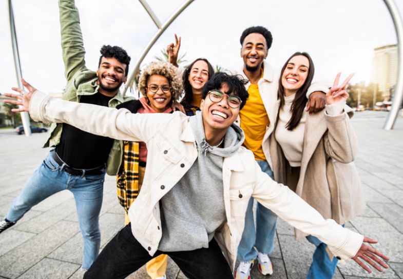 A group of international students smiling and posing for the camera A group of international students smiling and posing for the camera