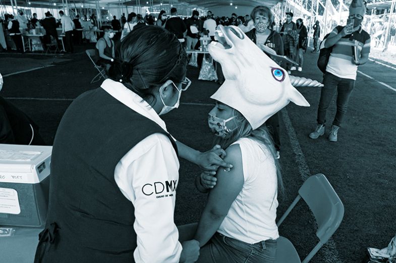 woman wearing unicorn hat gets vaccinated woman wearing unicorn hat gets vaccinated