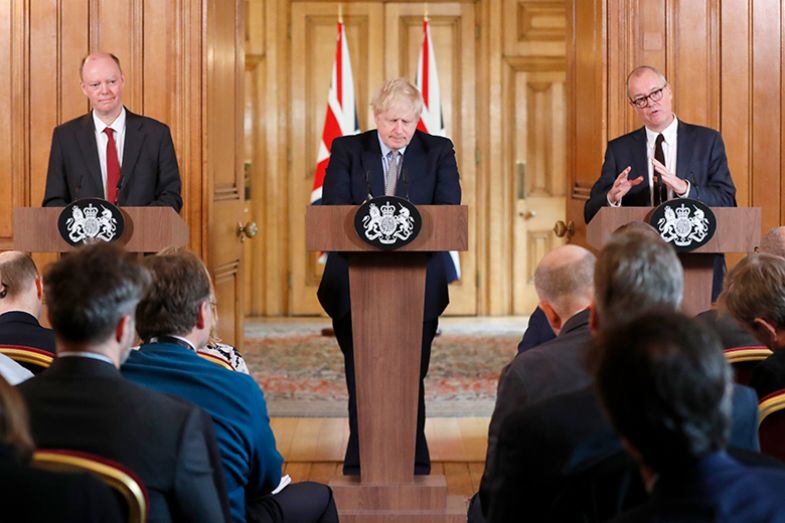 Boris Johnson, flanked by chief medical adviser to the UK government Chris Whitty (L) and the chief scientific adviser to the UK government Patrick Vallance (R), gives a press conference on 3 March 2020 to unveil government planning to combat coronavirus