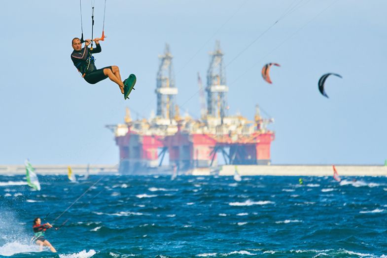 Kite surfer with tanker in the background Kite surfer with tanker in the background