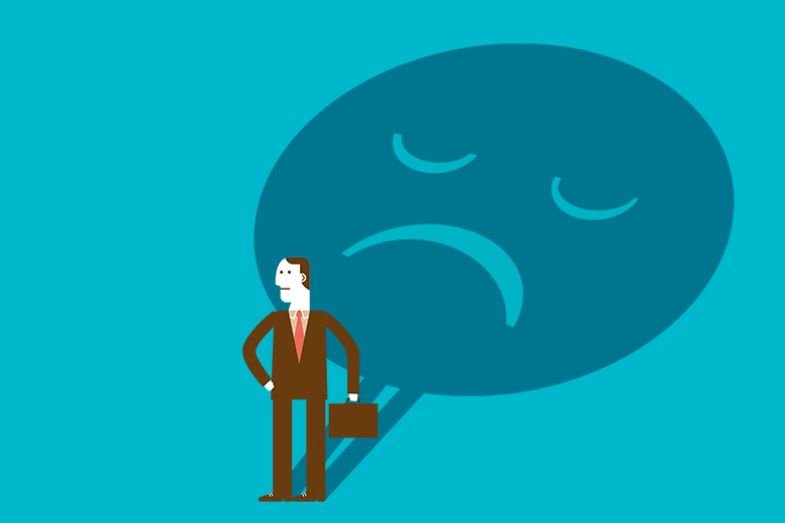 Man with a large unhappy shadow. To illustrate the increase in formal complaints at UK universities.