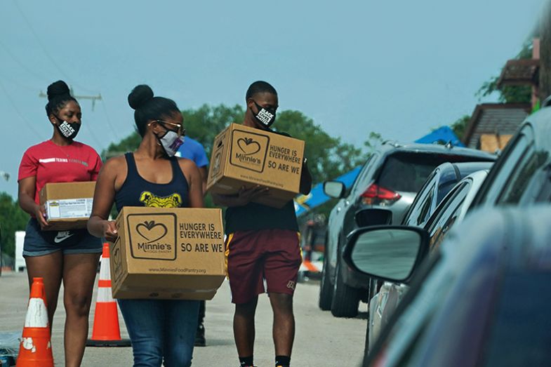Volunteers deliver food to cars at a Covid-19 testing site at Paul Quinn College in Dallas, Texas on 29 July 2020 Volunteers deliver food to cars at a Covid-19 testing site at Paul Quinn College in Dallas, Texas on 29 July 2020