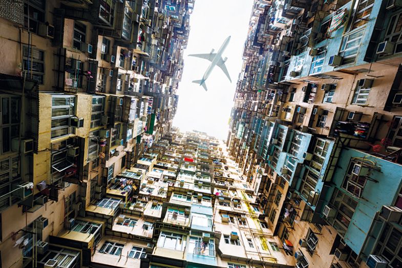 Plane above buildings