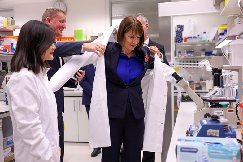Britain’s chancellor of the Exchequer Rachel Reeves puts on a lab coat as she and Britain’s secretary of state for science, innovation and technology Peter Kyle visit the Cambridge Biomedical Campus on 1 November 2024. Britain’s chancellor of the Exchequer Rachel Reeves puts on a lab coat as she and Britain’s secretary of state for science, innovation and technology Peter Kyle visit the Cambridge Biomedical Campus on 1 November 2024.