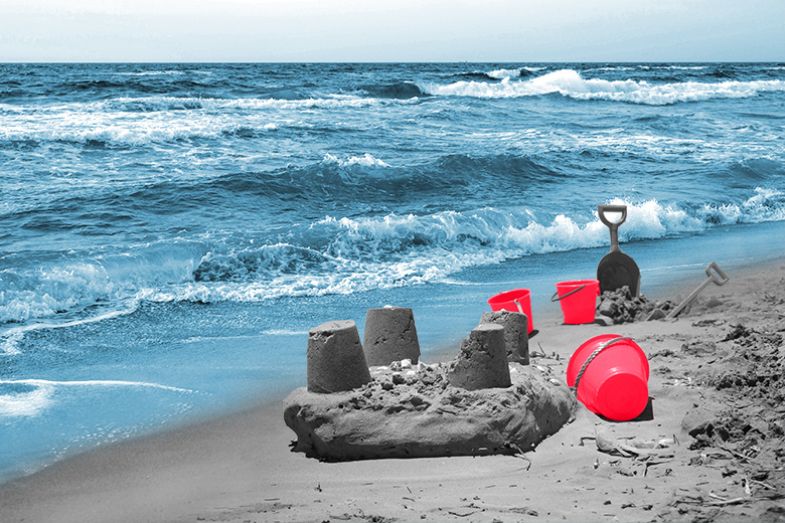 Sandcastle being washed away by the tide. To illustrate the question of whether the buckets model will protect UK science from being undermined by the populist tide.