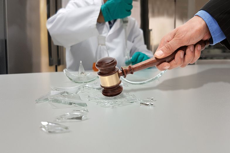 Smashing glass beaker with gavel Smashing glass beaker with gavel