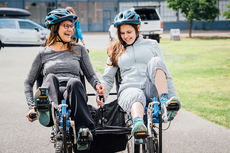 Mother and daughter on tandem bicycle Mother and daughter on tandem bicycle