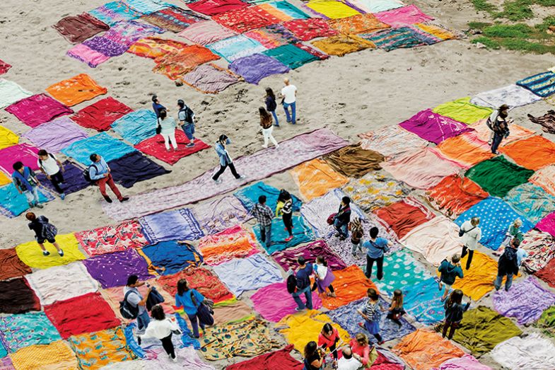 Montage of people walking over saris on beach Montage of people walking over saris on beach
