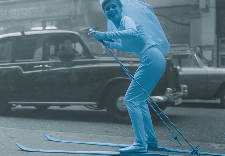 Bride using skies to travel on a road Bride using skies to travel on a road