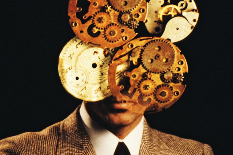 A man with a clockwork mechanism superimposed over his face A man with a clockwork mechanism superimposed over his face