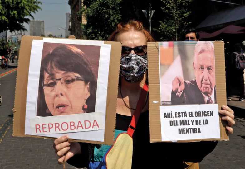 Protestor holding banners during a demonstration to demand the resignations of Maria Elena Alvarez - Buylla and Jose Antonio Romero Tellaeche Protestor holding banners during a demonstration to demand the resignations of Maria Elena Alvarez - Buylla and Jose Antonio Romero Tellaeche