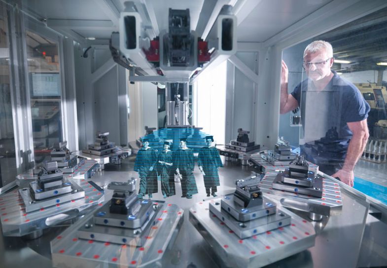 person looking at machinery with graduates inside