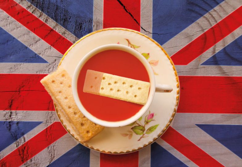 The Union Jack flag with a cup of tea served with a shortbread biscuit The Union Jack flag with a cup of tea served with a shortbread biscuit