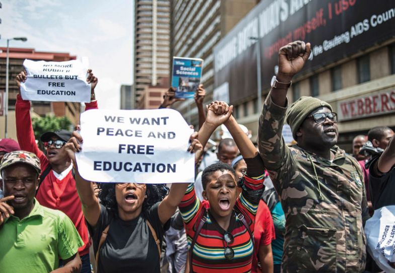 South African a student holds a placard reading 'We want peace and free education' during a protest in Pretoria South African a student holds a placard reading 'We want peace and free education' during a protest in Pretoria
