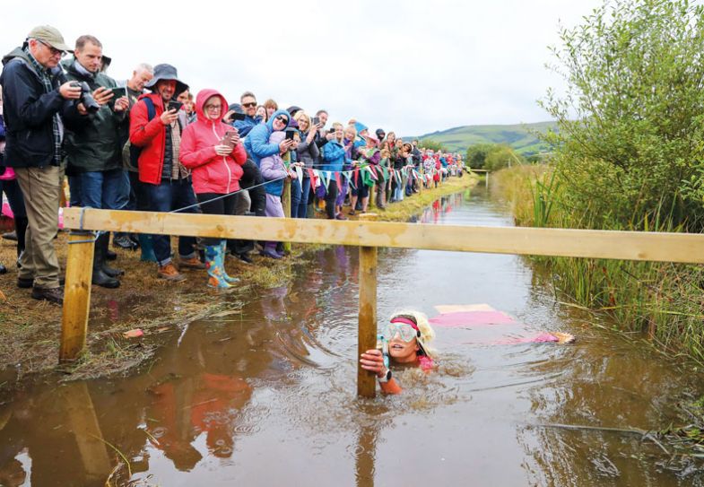 Lady in middle of muddy river taking part in the World Bog Snorkelling Championships Lady in middle of muddy river taking part in the World Bog Snorkelling Championships to illustrate Constrained by outdated policies