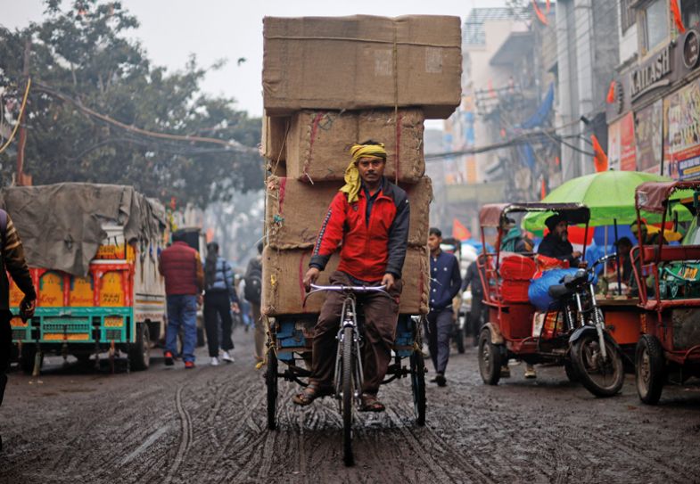 A man pulls a cart loaded with spice sacks at a wholesale market, a day before Indian Prime Minister Narendra Modi's government presents its final budget A man pulls a cart loaded with spice sacks at a wholesale market, a day before Indian Prime Minister Narendra Modi's government presents its final budget