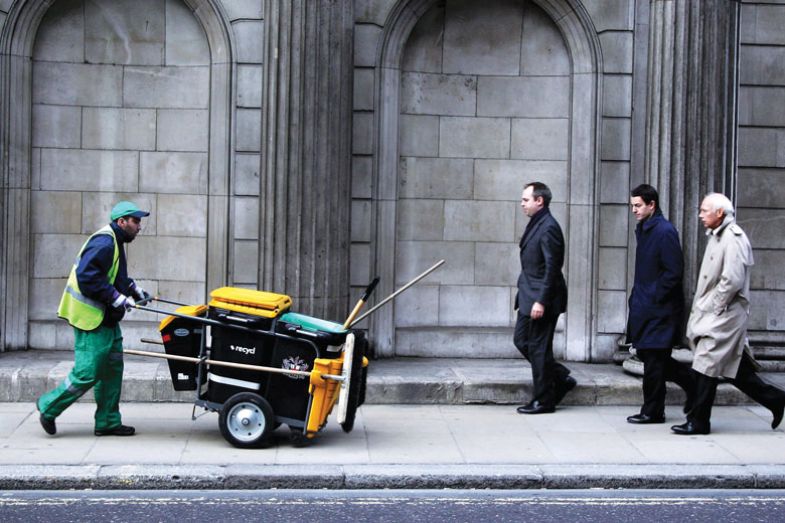 Man pushing dust cart in city Man pushing dust cart in city for book, The Sum of Us: What Racism Costs Everyone and How We Can Prosper Together
