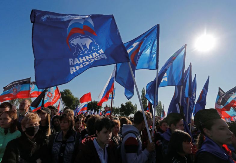 People hold flags of Russia's ruling United Russia party  People hold flags of Russia's ruling United Russia party