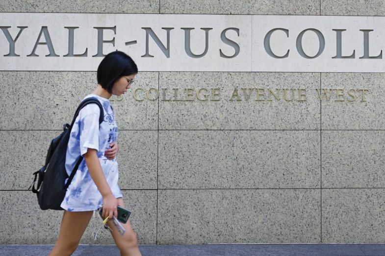 A student walking past signage for the Yale-NUS College in Singapore A student walking past signage for the Yale-NUS College in Singapore as described in the article