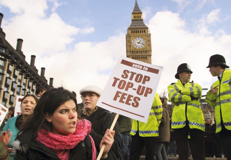 Protester carries a banner during a demonstration by university and college students Protester carries a banner during a demonstration by university and college students