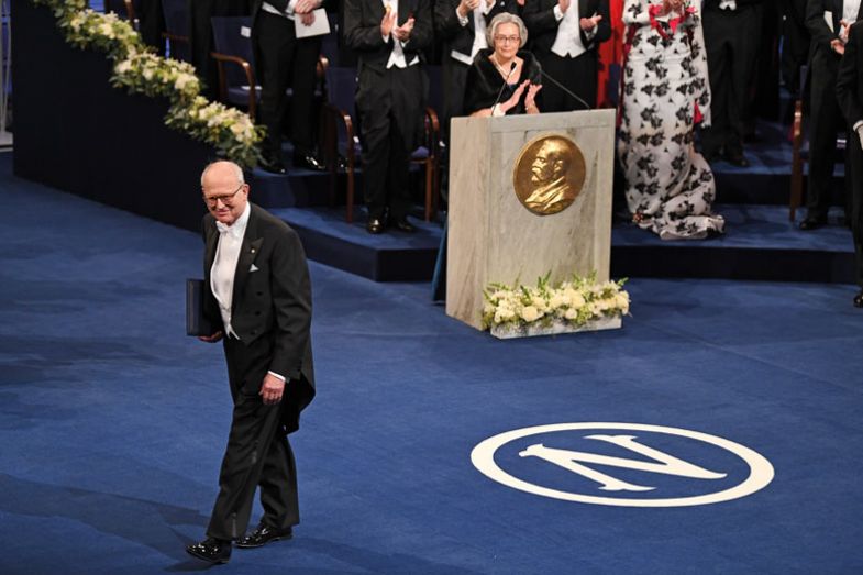 Thomas Octave Murdoch Sopwith (l), the British aviator, aircraft designer and sportsman, on his yacht the Endeavour with his crew, at Cowes, Isle of Wight with gold trophy cups