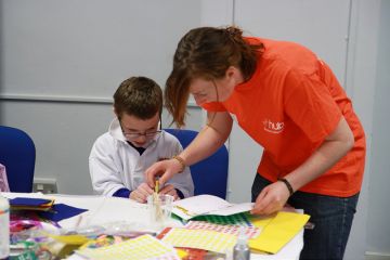 A student volunteering with children Student volunteering