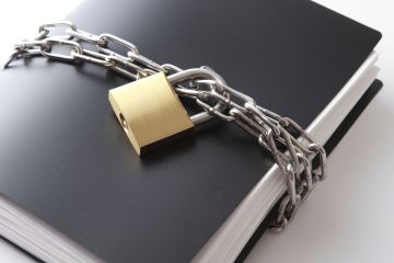Confidential documents locked with padlock and chain
