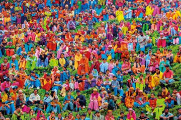 A large group of people wearing colourful clothing A large group of people wearing colourful clothing